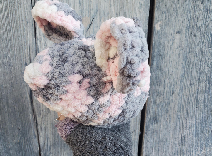 Crochet Plush mouse toy with gray and pink  on a wooden surface