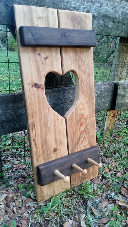 Cypress Wall Decor Coat Rack with a heart cutout, featuring three wooden pegs on a rustic design, ideal for hanging coats or keys.