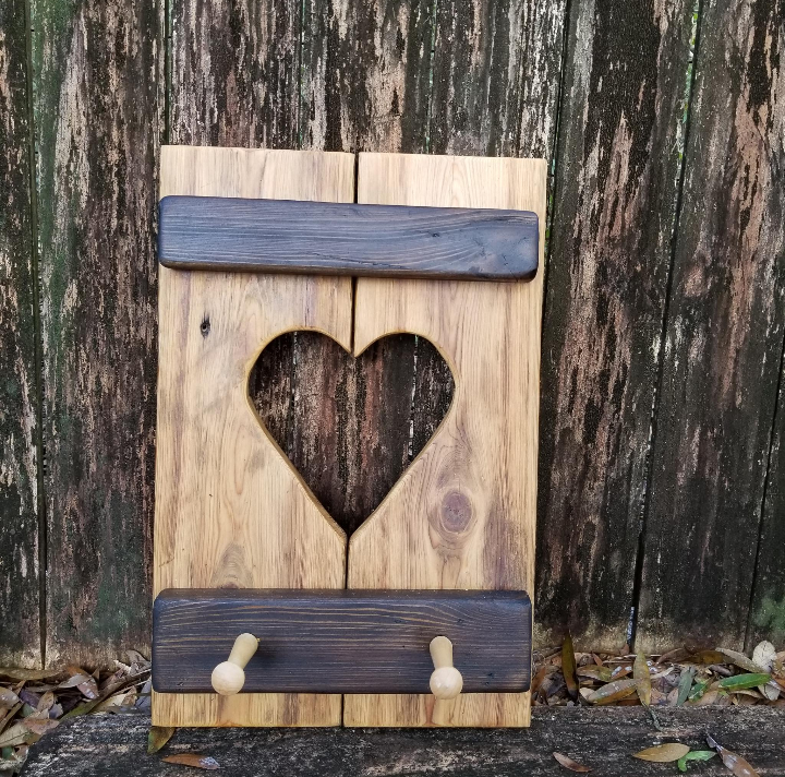 Cypress Wall Decor Coat Rack: A small, rustic wooden panel with a heart cut-out and two peg hooks for hanging lightweight items.