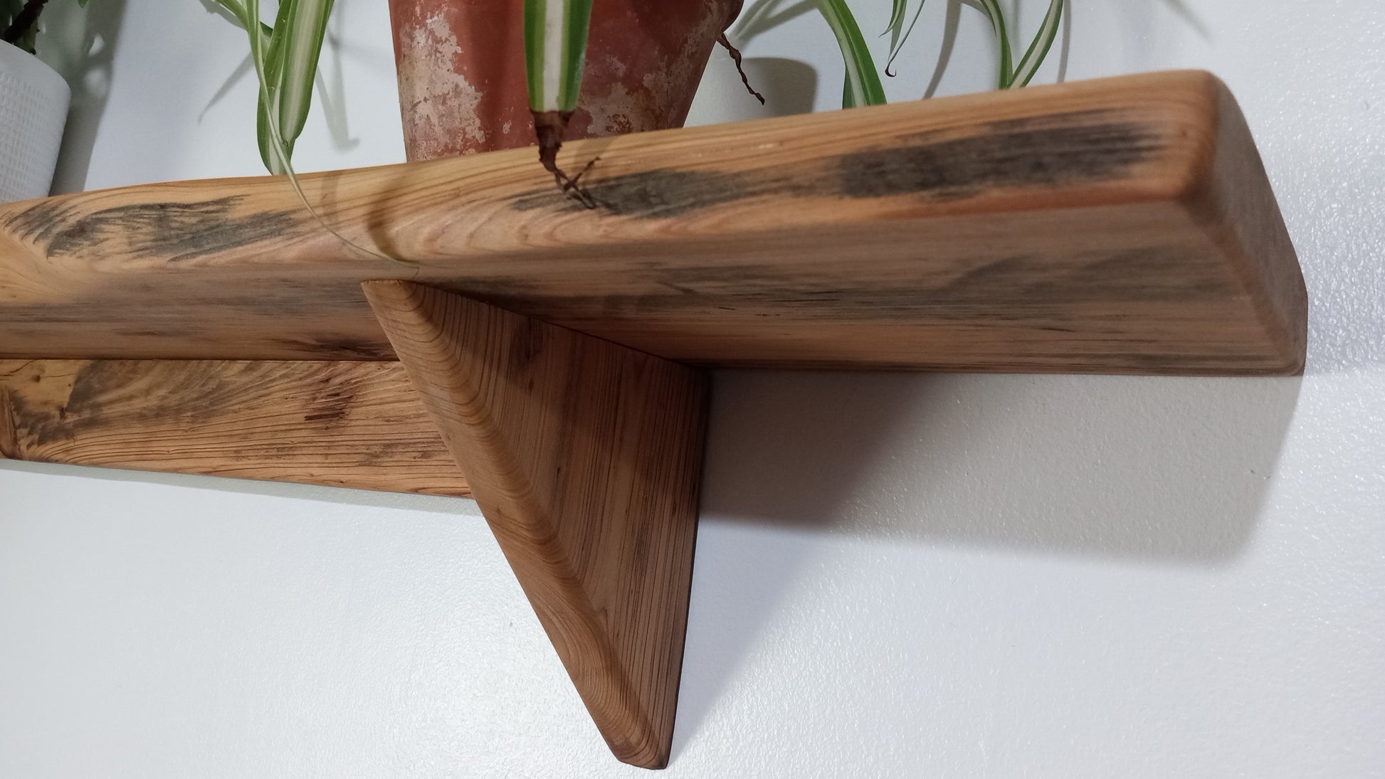 A closeup picture of the cypress wood used for this rustic wall shelf shows off the uniques grain.
