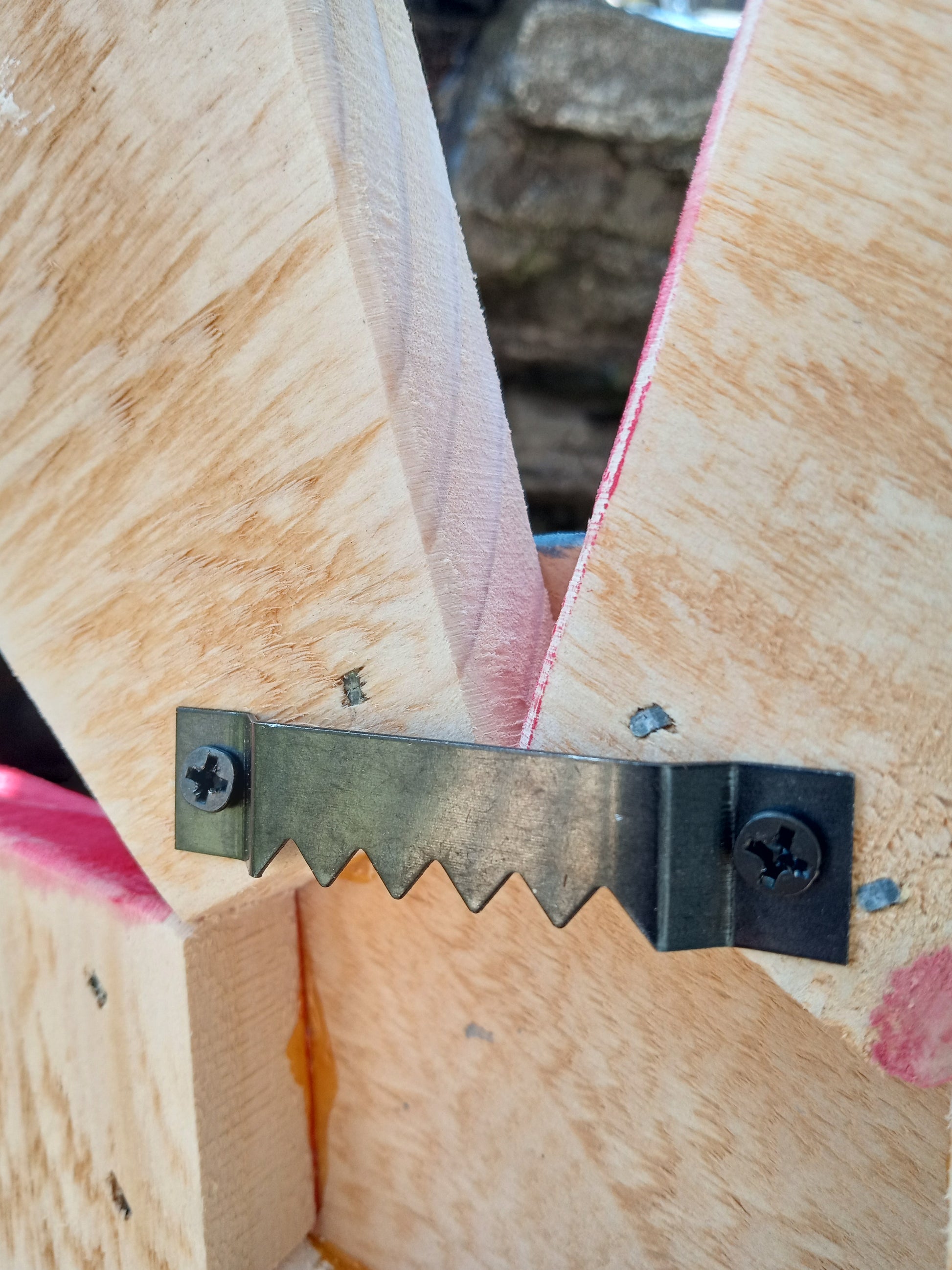 A close-up picture of the sawtooth hanger behind each sunflower allows for easy hanging.