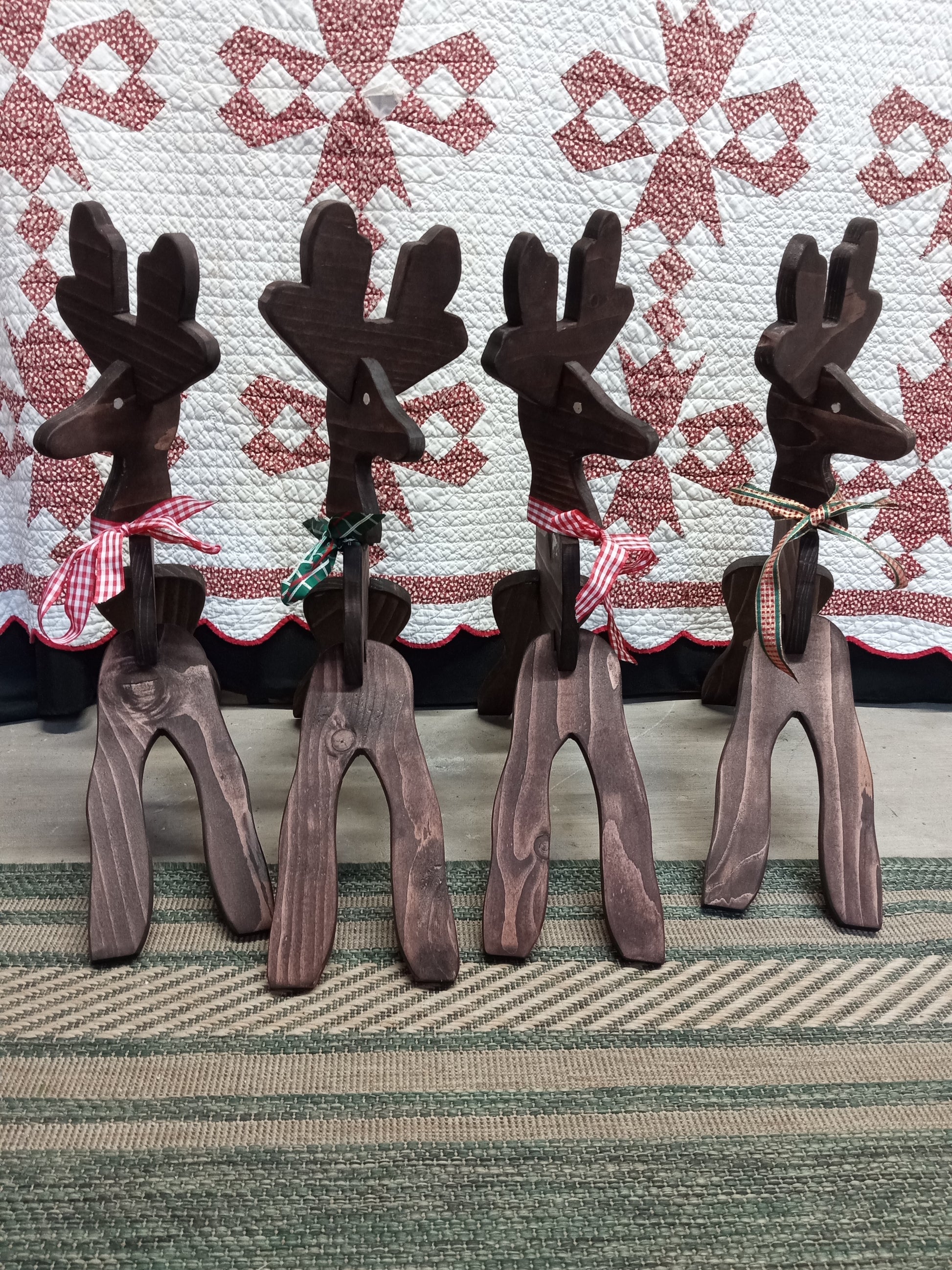 Set of wooden reindeer against a fabric background
