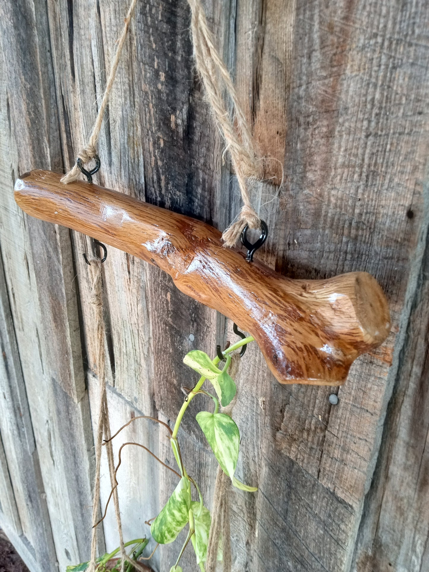 Wooden branch with a natural finish against a rustic wooden background