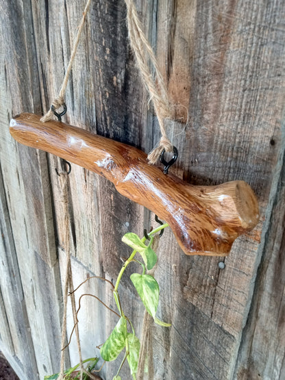 Wooden branch with a natural finish against a rustic wooden background
